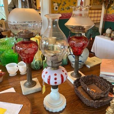 Antique Sandwich glass oil lamps, 19th century, marble bases with bronze columns topped with cranberry glass cut too clear