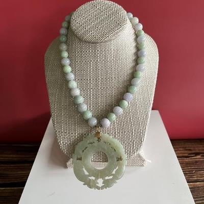 Multi-colored jade beaded necklace with a large antique jade pendant