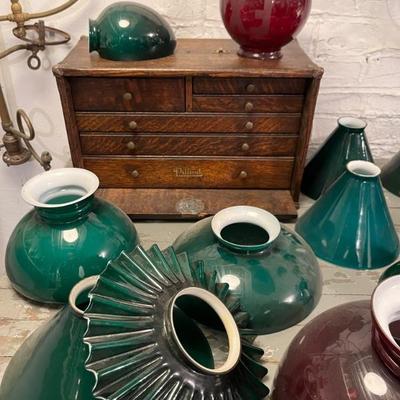 Lots of antique case glass lamp shades in green, milk glass, and red. Do you have an old lamp that needs a period replacement shade?