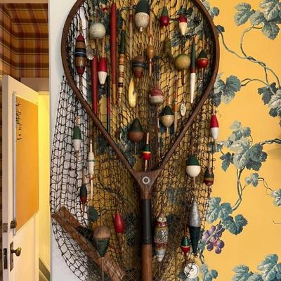 Antique fishing net decorated with antique and vintage fishing lures and floats