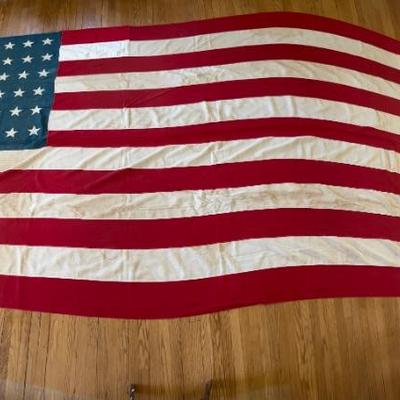 Huge early 48 star American flag, 8â€™ x 15â€™, all stitched with appliquÃ© stars, some minor water stains, c 1912-1917, around 1918...