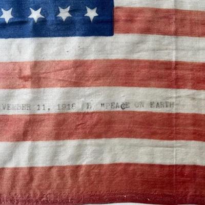 Armistice Day American flag, silk, 48 star, typed onto a white stripe â€œNovember 11, 1918 â€œPeace on Earthâ€ â€œ, framed, WWI