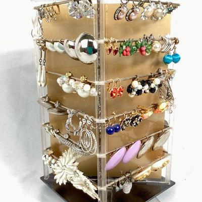 BIHY900 Display Rack Full Of Vintage Earrings	4 - sided spinning acrylic rack of clip on earrings in varioius shapes sizes and colors....
