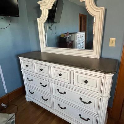 5 piece white distressed Bedroom set. No headboard. Includes dresser with mirror measures 64 x 19 x 40“ . Tall dresser with lift top...