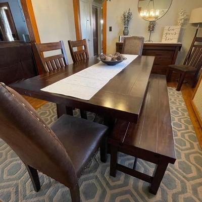 Dining table with 3 stow away leafs. Two leafs inserted in table as shown measures 48x78. Or 90â€ with 3rd leaf. Includes six chairs...