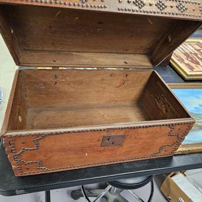 antique round top trunk with brass tacks