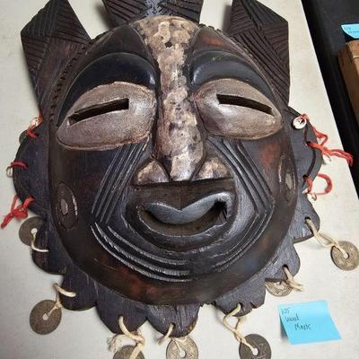 carved wood  mask with Asian coins