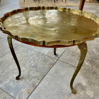 Lot 090-P: Small Round Wood-and-Brass Table

Features: 
â€¢	Vintage three-legged table with artisanal brass legs and brass platter/top....
