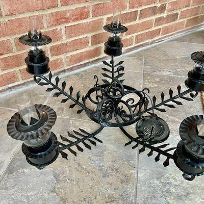Lot 094-P: Iron Chandelier

Features: 
â€¢	Five-armed fixture
â€¢	Each bulb is ensconced within a glass chimney; each chimney is ringed...