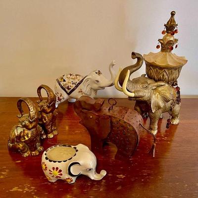 Lot 039-P: Here Come the Elephants! (Lot #2)

Description: 
â€¢	Assorted ceramic, metal, and wood elephant figurines
â€¢	The largest...