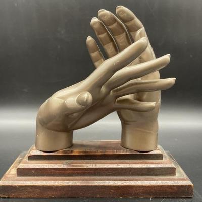 Plastic Hand Sculpture on Wooden Base