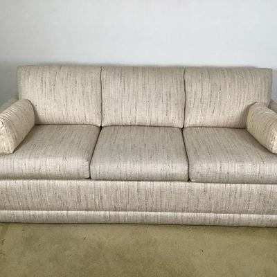 ELDA214 Sleeper Sofa	Cream color sleeper sofa. Has 2 arm rests coverings. Seat cushions do separate, 2 throw pillows. Does fold out to a...
