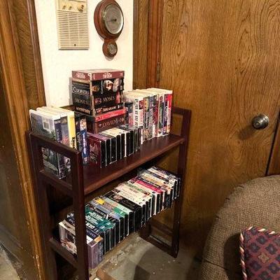 DVDs, CDs, VHS tapes, cassettes on a folding bookcase