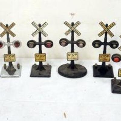 1211	GROUP OF ASSORTED TRAIN O GAUGE METAL CROSSING SIGNALS
