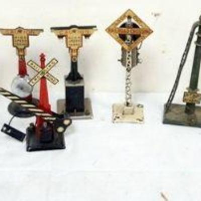 1212	GROUP OF ASSORTED TRAIN O GAUGE METAL CROSSING SIGNALS
