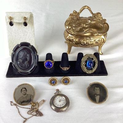 BIHY101 Antique Jewelry & Victorian Casket Jewelry Box	An assortment of antique and vintage jewelry, as well as a gold colored Victorian...