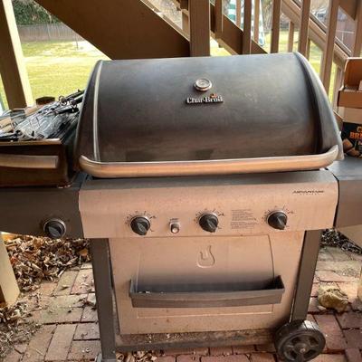 CharBroil gas grill with grill tools and extras.