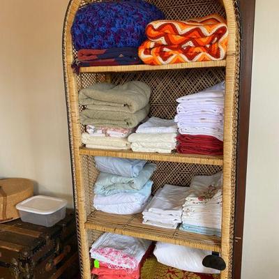 Wicker shelf full of linens