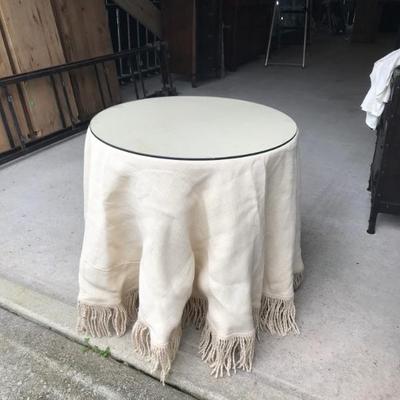 Ballard Designs round glass top side table with burlap tablecloth. A second darker burlap tablecloth is also in the sale. 