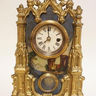 1049	ORNATE VICTORIAN CAST METAL CLOCK OVER WOOD CASE DIPICTING HAND PAINTED CASTLE SCENE, APPROXIMATELY 4 IN X 9 IN X 12 IN HIGH
