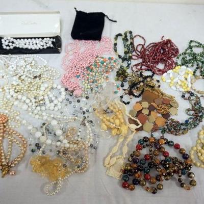 1275	LARGE LOT OF ASSORTED NECKLACES INCLUDING BEADED AND JOAN RIVERS
