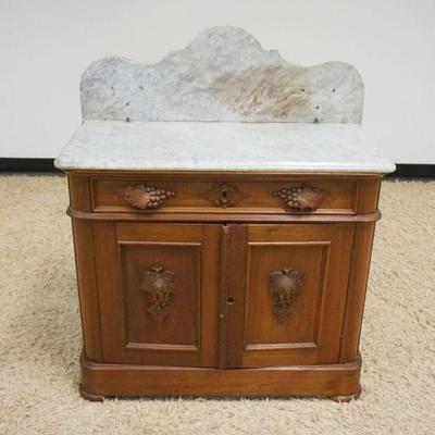 1109	ANTIQUE WALNUT VICTORIAN WASHSTAND, MARBLE TOP W/CARVED GRAPE CLUSTER PULLS, LOSS & REPAIR TO MARBLE TOP, APPROXIMATELY 34 IN X 17...