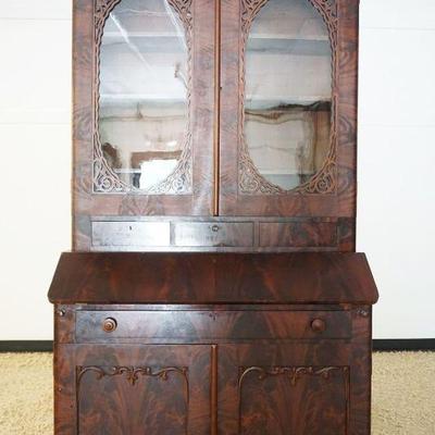 1107	FLAMED MAHOGANY EMPIRE STYLE 2 PART SECRETARY DESK W/FRETWORK CUT OUT TRIM ON DOORS, APPROXIMATELY 49 IN X 21 IN X 89 IN HIGH
