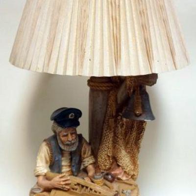 1253	COMPOSIT FIGURAL TABLE LAMP DEPICTING RETIRED SHIPS CAPTAIN BUILDING A MODEL SHIP, APPROXIMATELY 26 IN H
