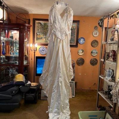 Back view of wedding gown hanging from ceiling