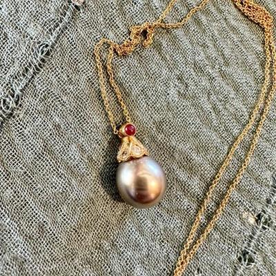 Black Tahitian pearl with diamond, emerald, ruby topper
