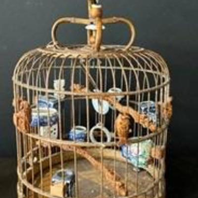 Vintage Chinese Bamboo Bird Cage With intricate carved figurines such as a turtle, fish, dragons and more. 

Interior of the cage...