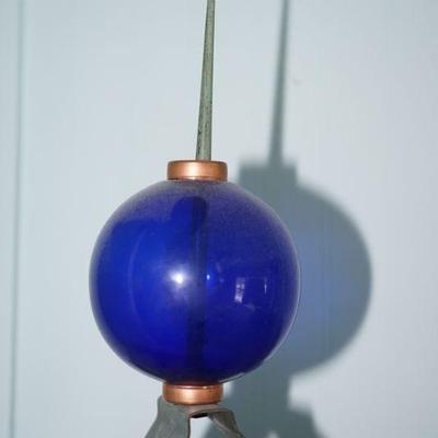 cobalt blue lightening rod ball with just the top of the rod for support. 