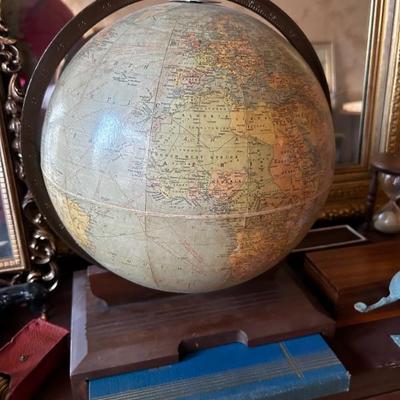antique globe with handbook insert