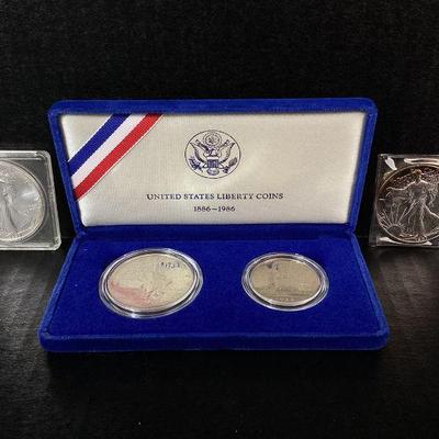 SHBR100 Liberty Silver Dollars	A pair of minted United States Liberty coins with their original blue case, and 2Â silverÂ Liberty dollar...