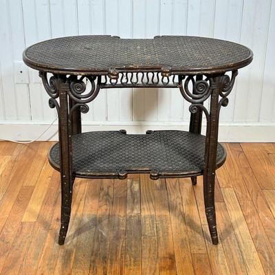 WAKEFIELD RATTAN CO. AESTHETIC TABLE | An ornate wicker table with woven top surfaces and faux bamboo turnings. Original label on...