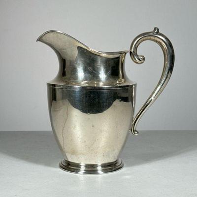 WALLACE STERLING SILVER PITCHER | Sterling silver water pitcher with a scroll handle; 18.95 ozt