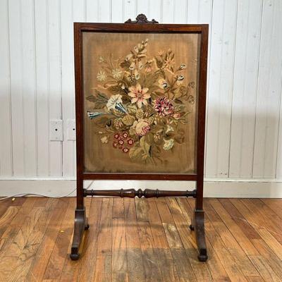 ANTIQUE NEEDLEPOINT FIRE SCREEN | Antique needlepoint behind glass in a carved rosewood frame with turned decorations