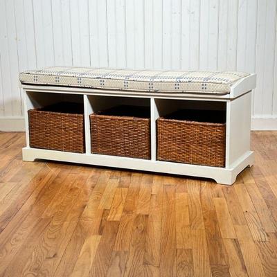 WINDOW BENCH | White painted wooden bench with three storage cubbies, having a removable woven seat cushion