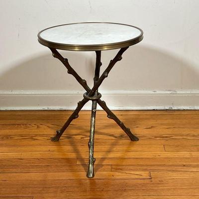 STONE & BRASS SIDE TABLE | Circular off-white stone top with brass border over brass tripod legs in the form of branches. Label on...