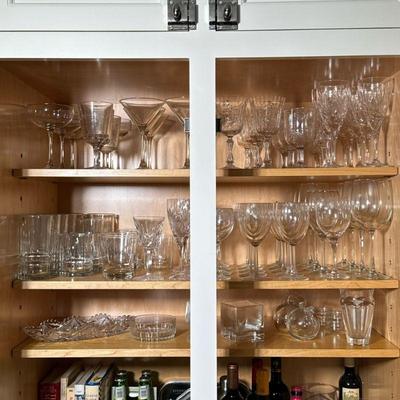 (75PC) BACCARAT VASE & STEMWARE, GLASSWARE LOT | Cabinet full of glassware including martini, whiskey, wine glasses, etc.