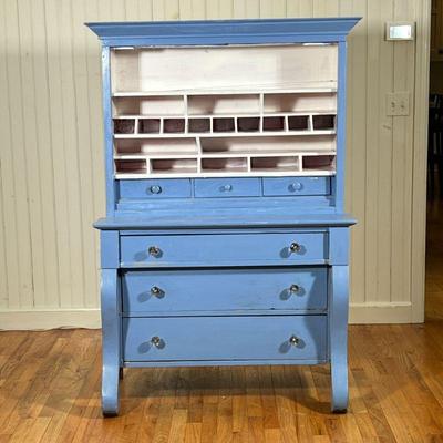 ANTIQUE CUPBOARD DRESSER | Piece is painted blue and having multiple rows of shelves and small compartments over 3 split width drawers...