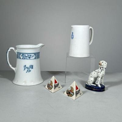 (5PC) STAFFORDSHIRE DOG & BASS ALE LOT | Including an flared Exeter pitcher, a Bovey Pottery pitcher, two Bass Ale triangles, and a...