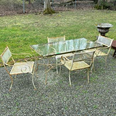 IRON OUTDOOR PATIO SET | Includes: glass top rectangular table with wrought iron designs, and 4 grated iron patio chairs Table...