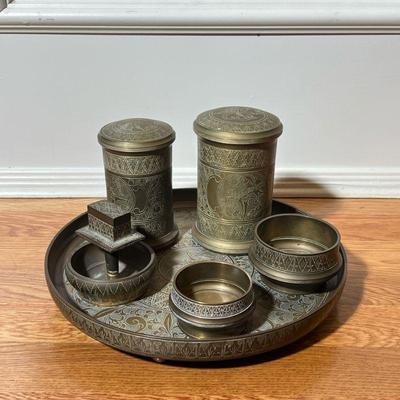 (6PC) CHASED ENGRAVED BRASS ITEMS | Including two cylindrical vessels to open low form vessels and ashtray with handle, and a footed...