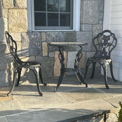 OUTDOOR COCKTAIL SET | Includes: 2 cast iron chairs with grape motifs and circular glass top iron table with similar grape motifs Table...