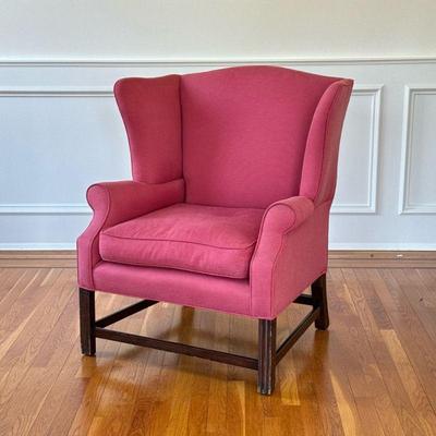 UPHOLSTERED WING CHAIR | Having a wide form, pinkish-red upholstery Seat 19 in. At cushion