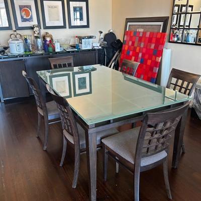 Glass top dining table with a set of 6 chairs