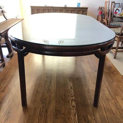 Walnut wood recessed leg  dining table shown with 2 leaves in.  The top of the table has removeable glass cover to protect the surface....