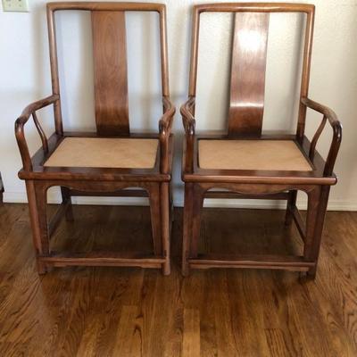 2 Walnut dining armchairs with wicker inset seat. (Selling with the dining table)