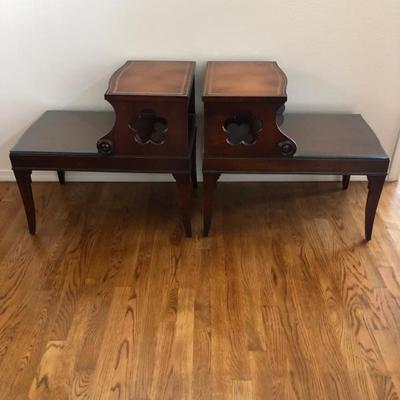 Side view of vintage leather top step end tables.